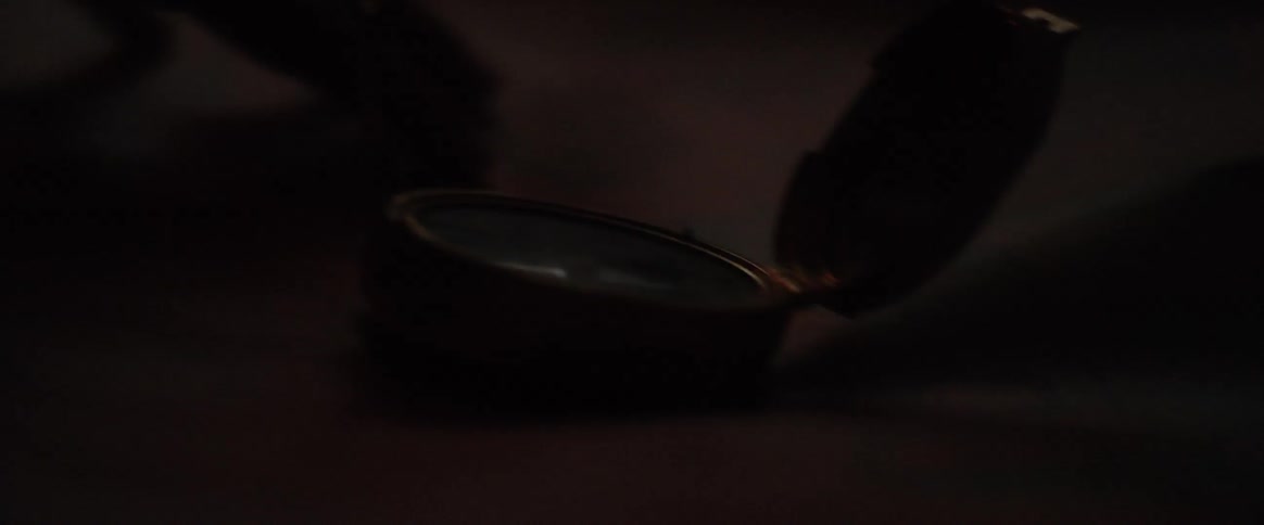An open compass sits on a map as a hand traces routes
