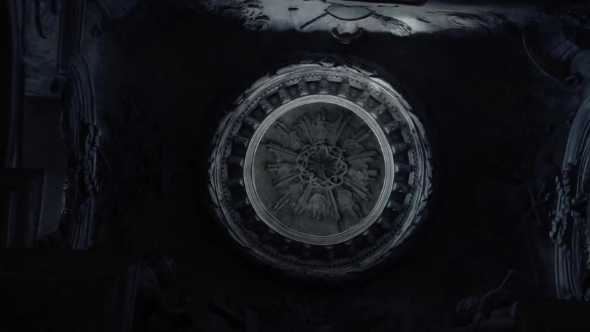 A large disk sits in a dark room
