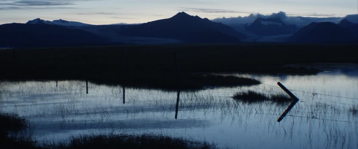 A scenery of a lake and mountain range