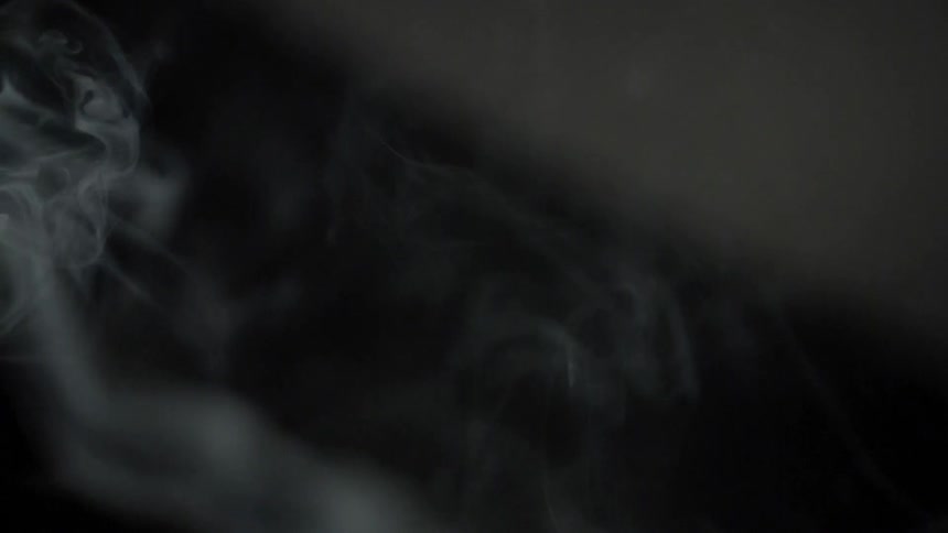 Smoke rising with a black and gray background