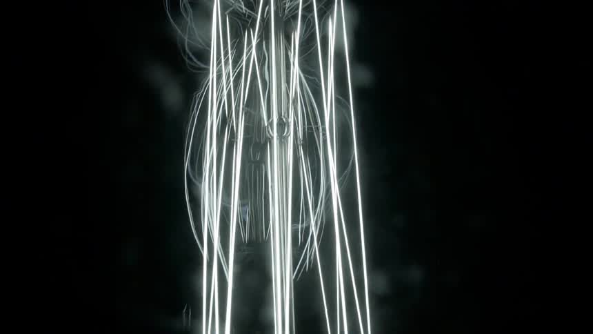 Electrical light filaments glow and shine against a black background