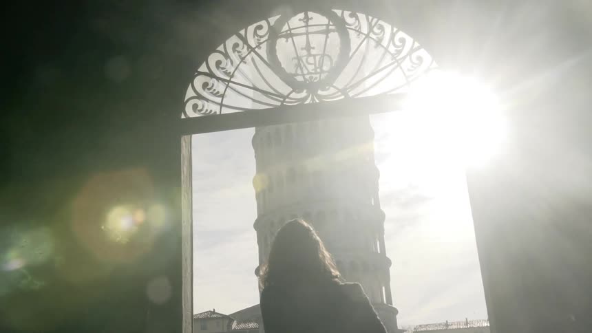 A woman walking towards window under the sun flare