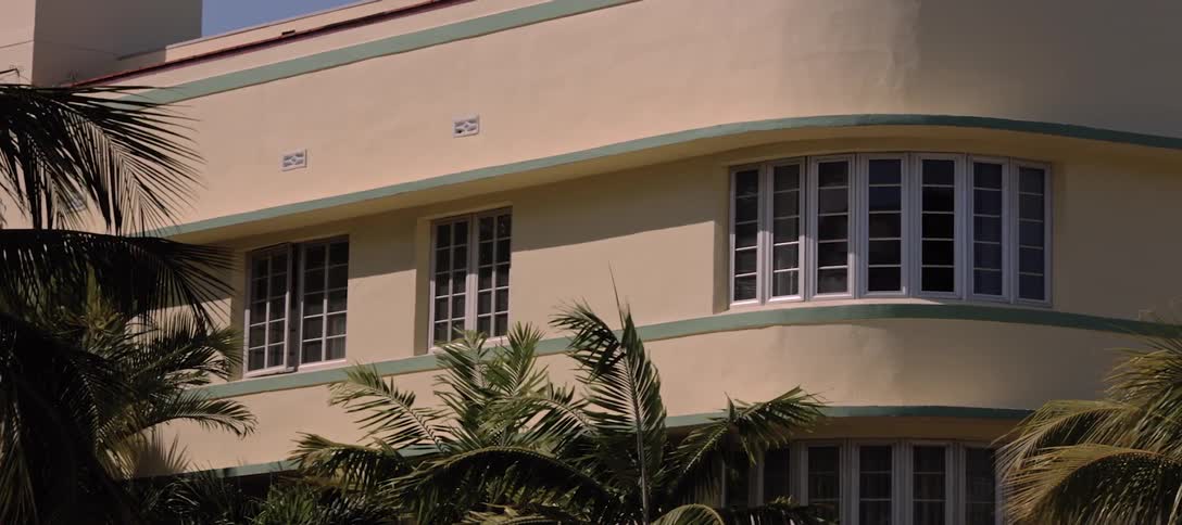 A panning shot of a beige art deco building