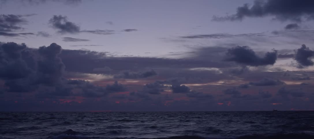 A cloudy sky that is above the ocean