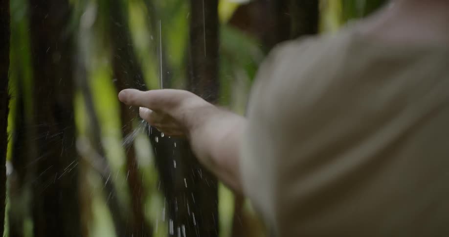 A hand trying to reach dropped water
