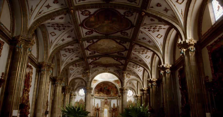 Empty cathedral topped with elaborate painted and carved ceiling