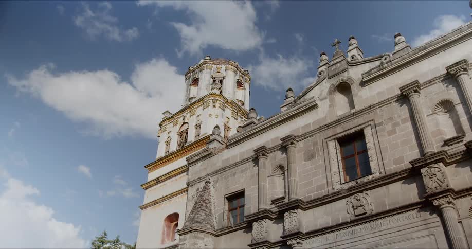 View of the church of san juan bautista and its tower under the blue sky