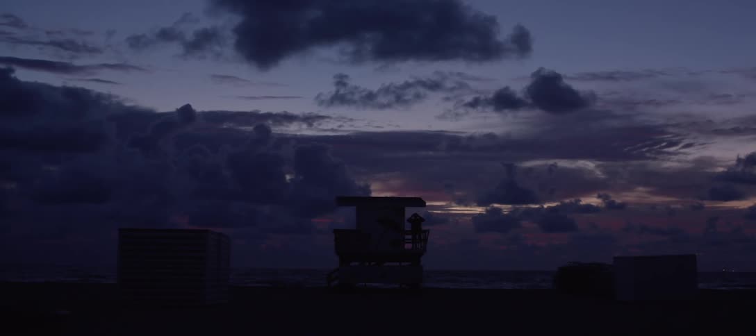 A person on a lifeguard tower on the beach