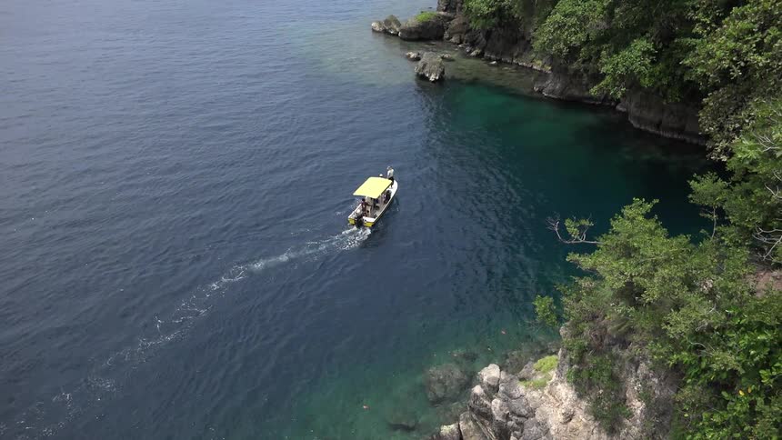 A boat travelling near the shore