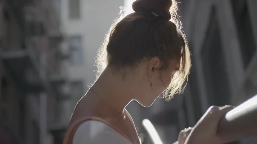A woman with auburn hair prepares for a dancing session