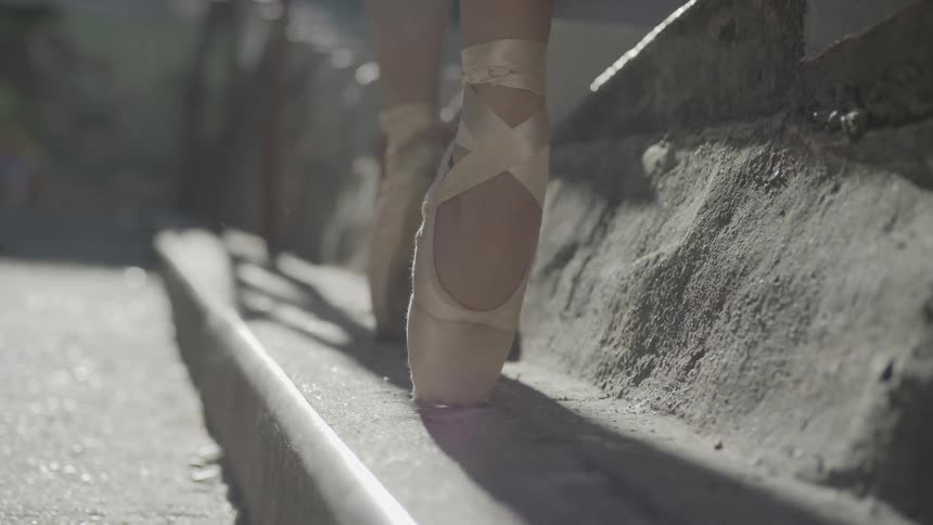A woman dancing on stairs outside