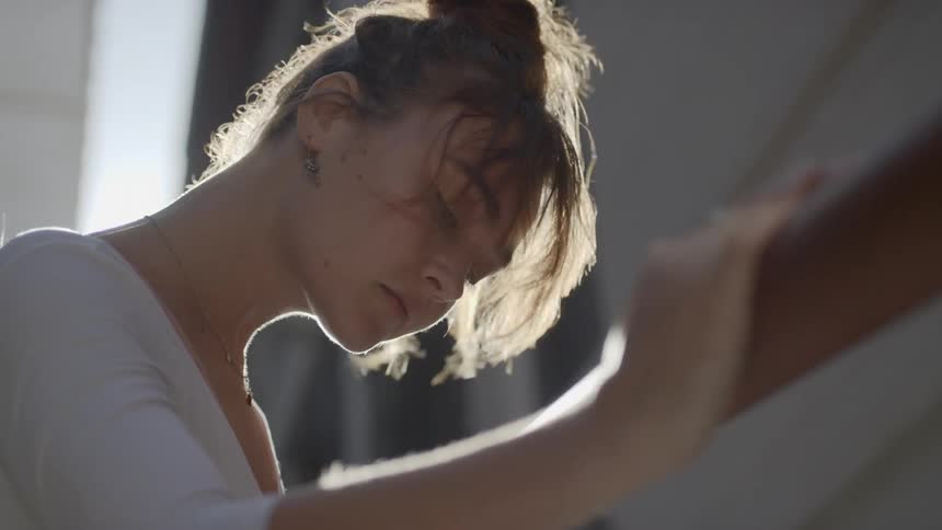 Ballerina warms up before dancing outdoors on a windy day