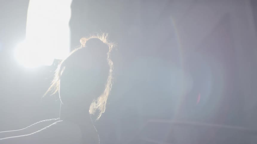 A woman dances by herself in the city street