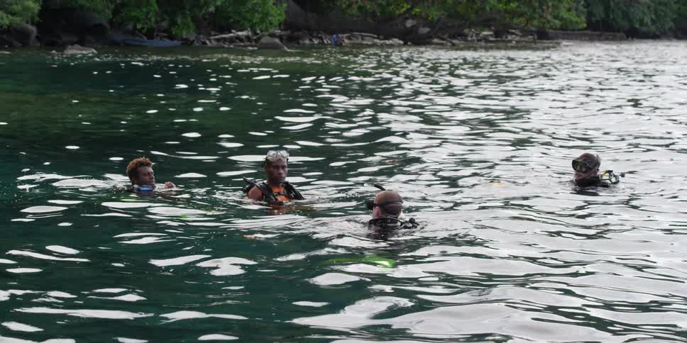 A group of divers talking in the water