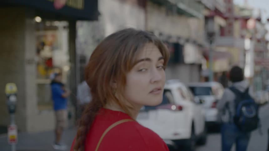Woman glances over street scene
