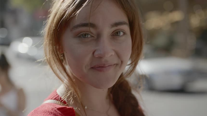 A woman with auburn hair smiles for the camera