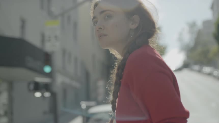 A woman walks across a street