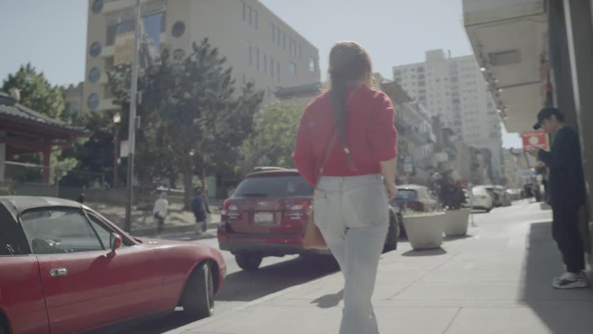 A woman walks down a city street