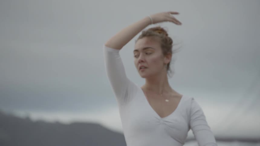 A woman dances and twirls in a circle