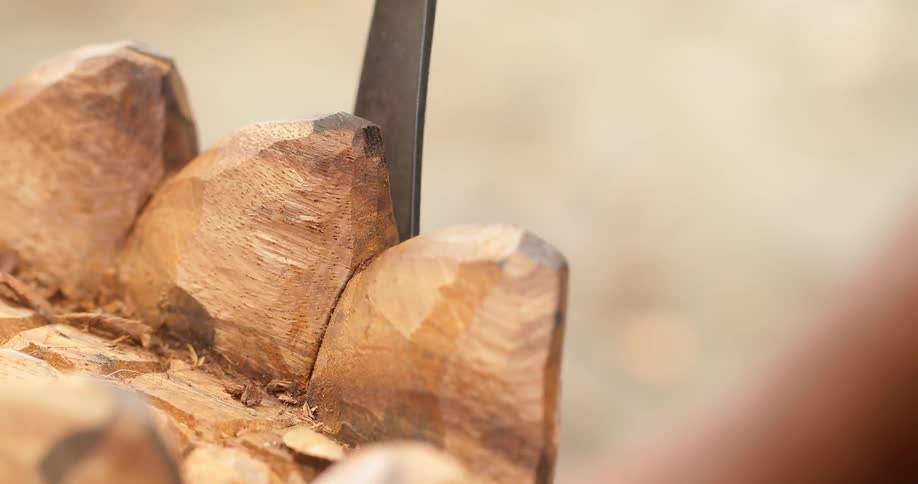 Someone chiseling a piece of wood
