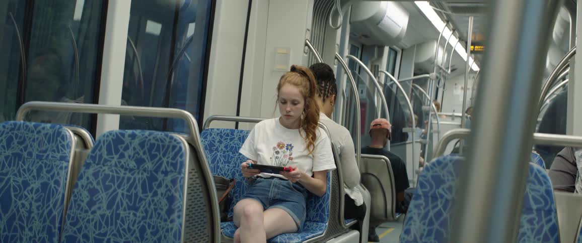 Woman views her tablet as she rides on the subway
