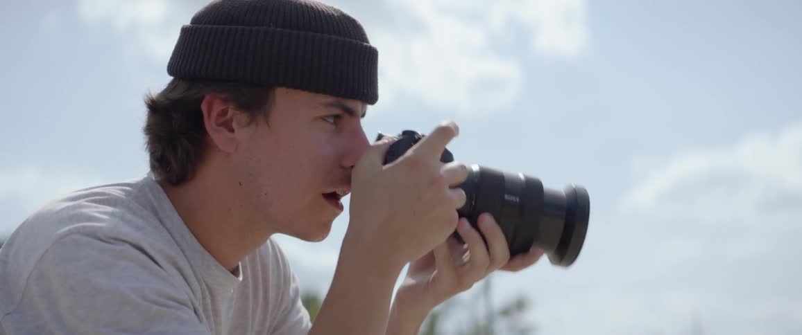 A young man takes pictures with his camera