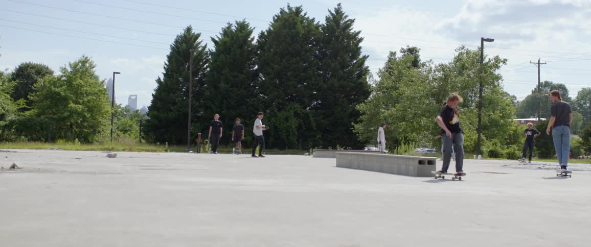 Teens skateboard in a makeshift skate park