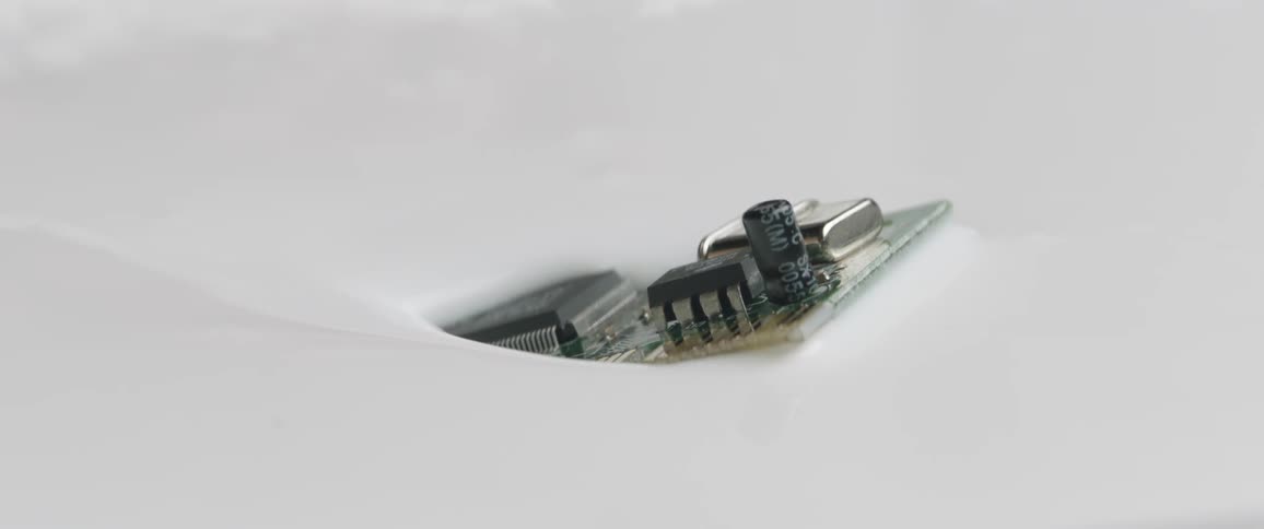 A metal component sinks in to white paint