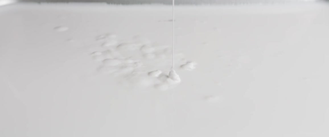 White paint dripping in to more white paint