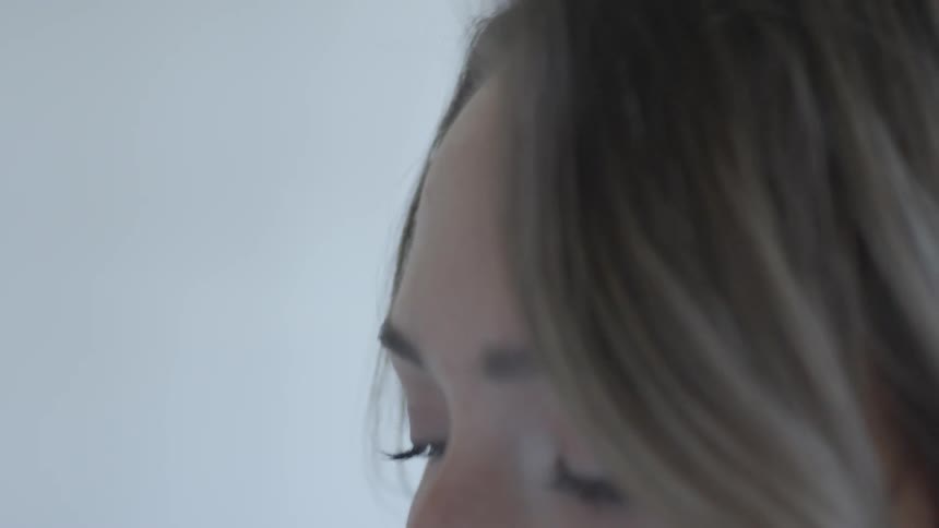 A woman looking into the sky then at the ground