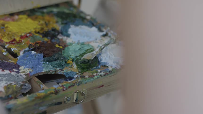 A tool is being used to mix paint