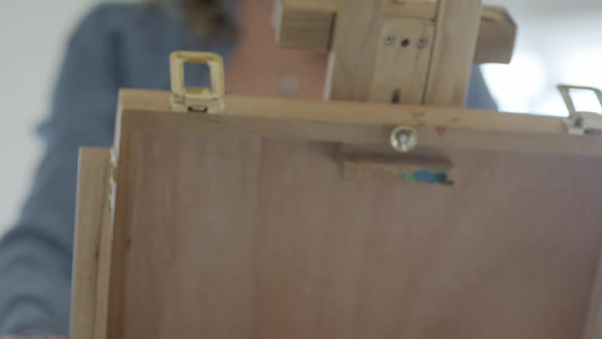 Woman raises a lid on a wooden box