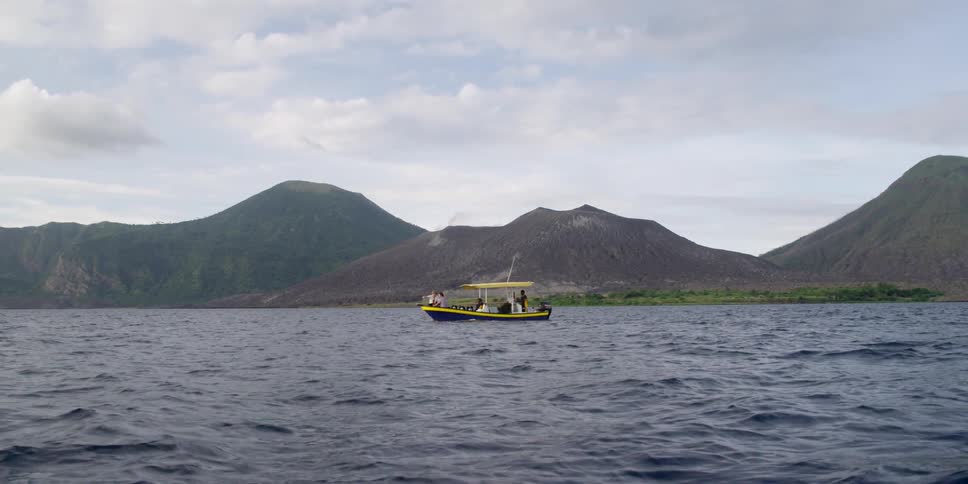 A boat is traveling on rough waters on a cloudy day