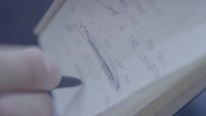 Close up of person handwriting notes in a notebook with a pen