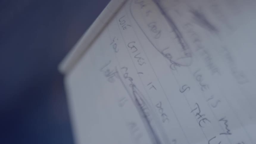 A person writes in a notebook