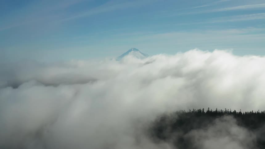 A scenery of a mountain above the clouds