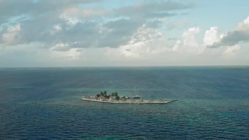 A small island sits in the middle of the cean