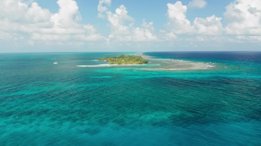 An island in clear blue tropical waters