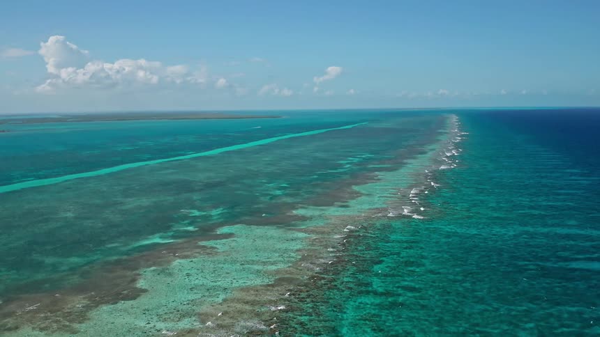 A coral reef with the sky and clouds in the background
