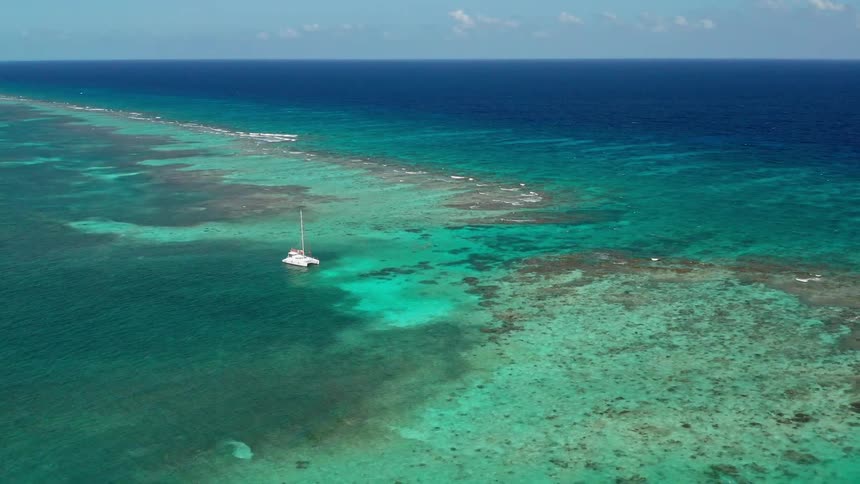 A boat in clear green and blue ocean water