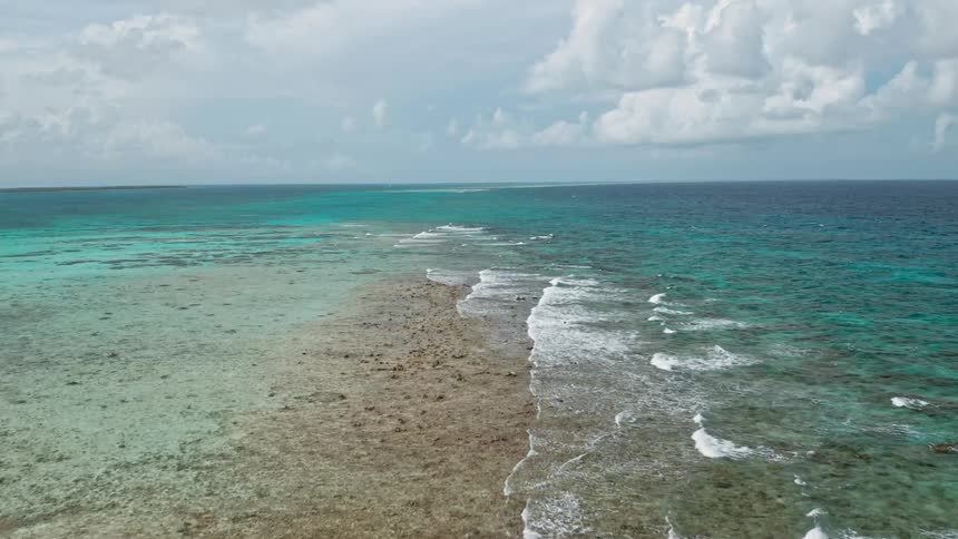 Crystal clear tropical waves break and splash