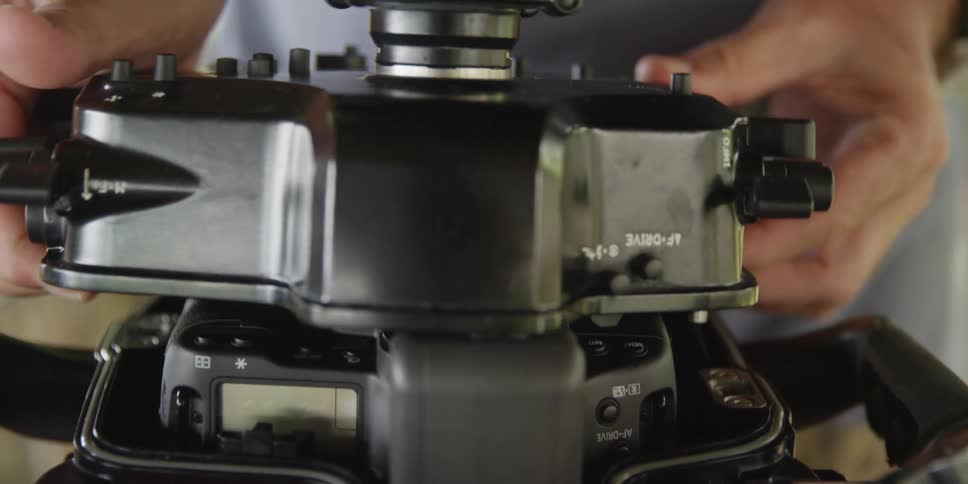 A man is putting the casing on a black device