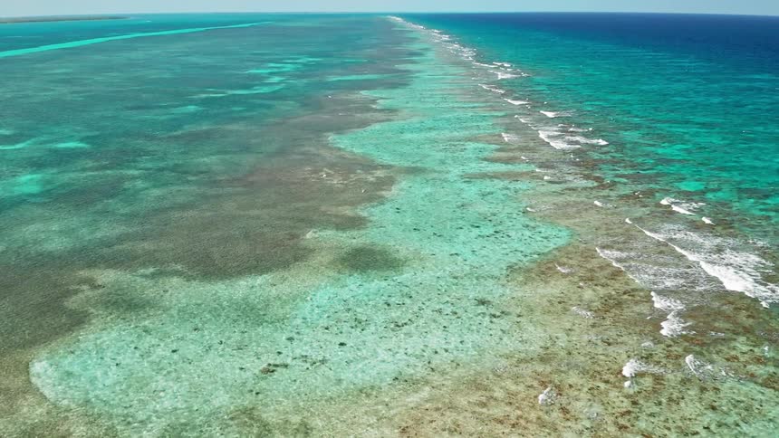 Waves flow along surface of clear blue ocean water
