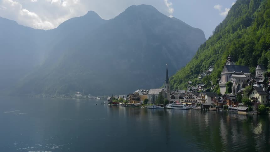 A town close to a lake with mountains in the background
