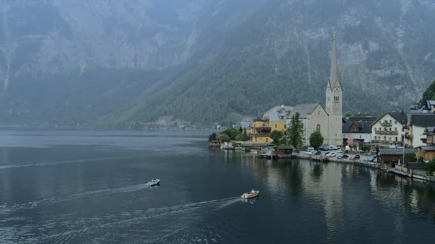 Boats head into dock in town at base of mountain