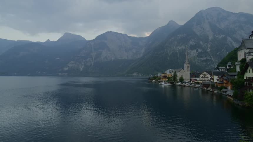 Landscape view of the mountains lake and buildings on the shore