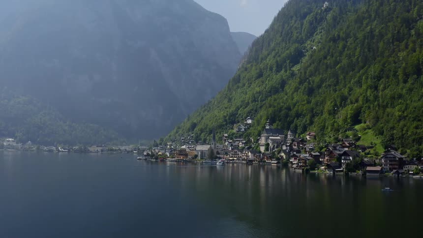 The homes are set on the side of the mountain by the water