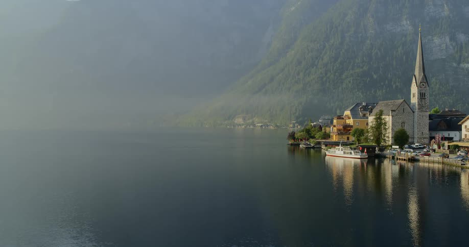 A church sits next to the mountain and lake