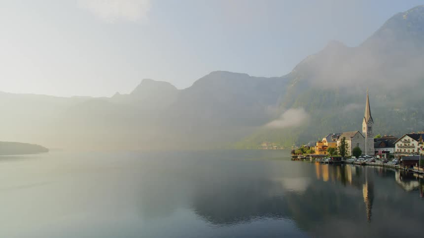 A church and village on lake hallstatt in austria