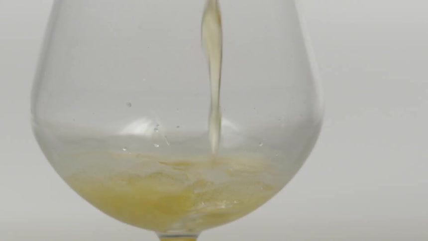 A pale ale is poured into a clear glass